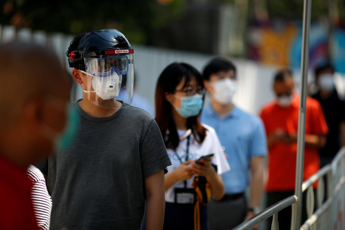 People line up to receive a nucleic acid test at a testing vehicle, following a new outbreak of the coronavirus disease (Covid-19) in Beijing, China, June 30, 2020. Credit: Reuters Photo