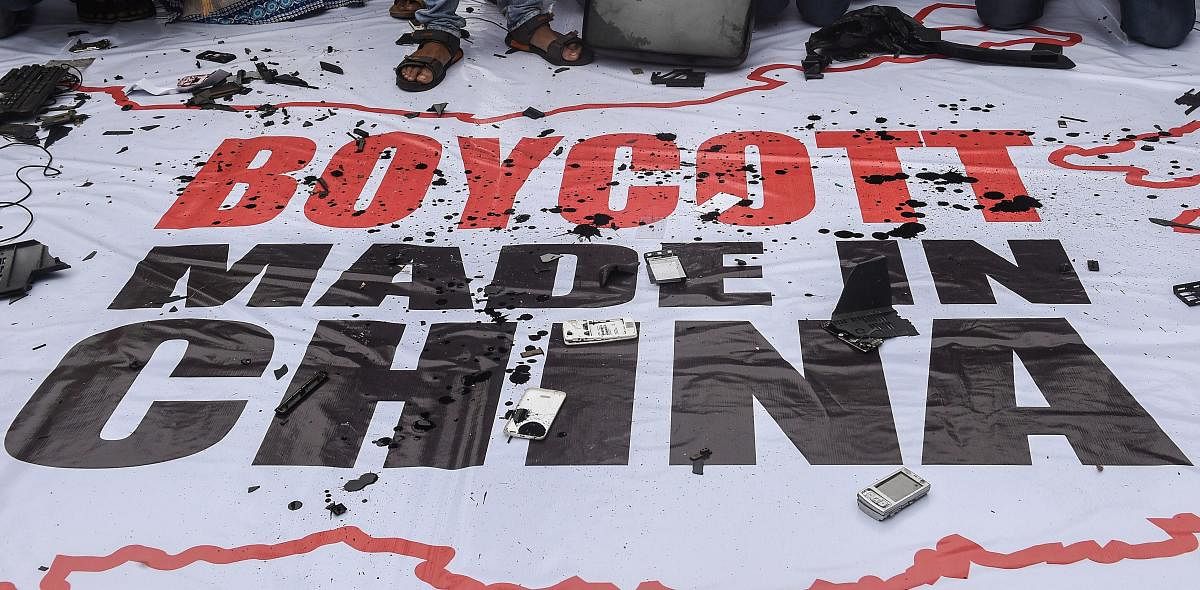 Mangled remains of Chinese products are seen lying on a banner that reads 'Boycott Made In China' during a protest by Youth Congress activists over the killing of 20 Indian Army soldiers in Ladakh's Galwan Valley by the Chinese People's Liberation Army (PLA) troops, in Kolkata, Thursday, June 18, 2020. Credit/PTI Photo