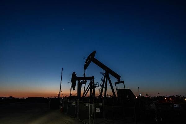 Oil pump jacks operate at dusk Willow Springs Park in Long Beach, California on April 21, 2020. Credit: AFP Photo