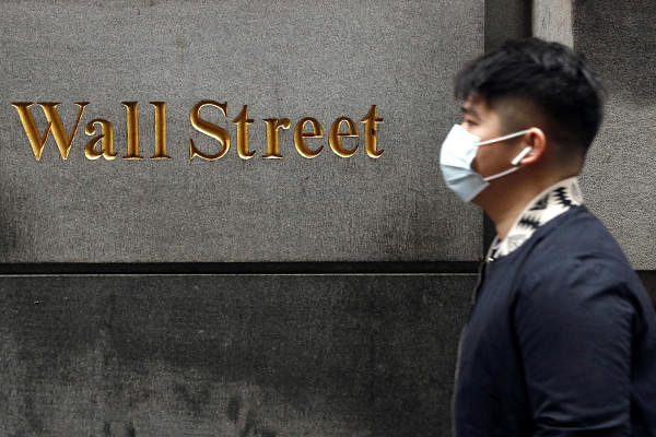 A man wears a protective mask as he walks on Wall Street during the coronavirus outbreak in New York City, New York, U.S., March 13, 2020. Credits: Reuters Photo