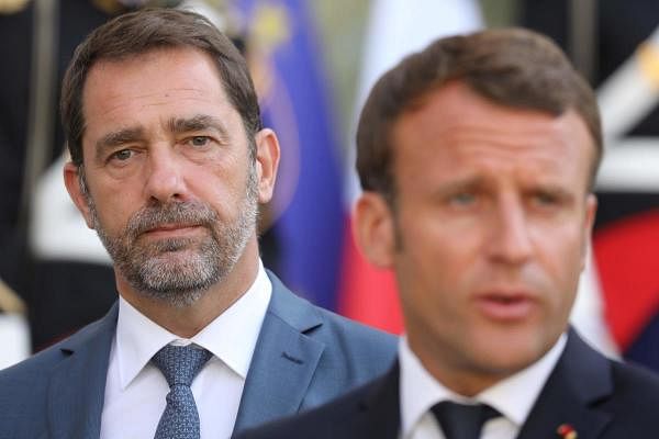 French Interior Minister Christophe Castaner (L) listens to French President Emmanuel Macron speaking to journalists after a meeting focused on migration at the Elysee presidential Palace in Paris. Credits: AFP Photo