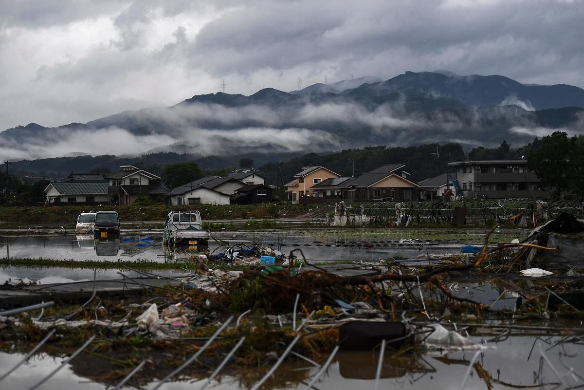 Debris are seen on a paddy field near a residential area hit by torrential rain, in Hitoyoshi (AFP Photo)