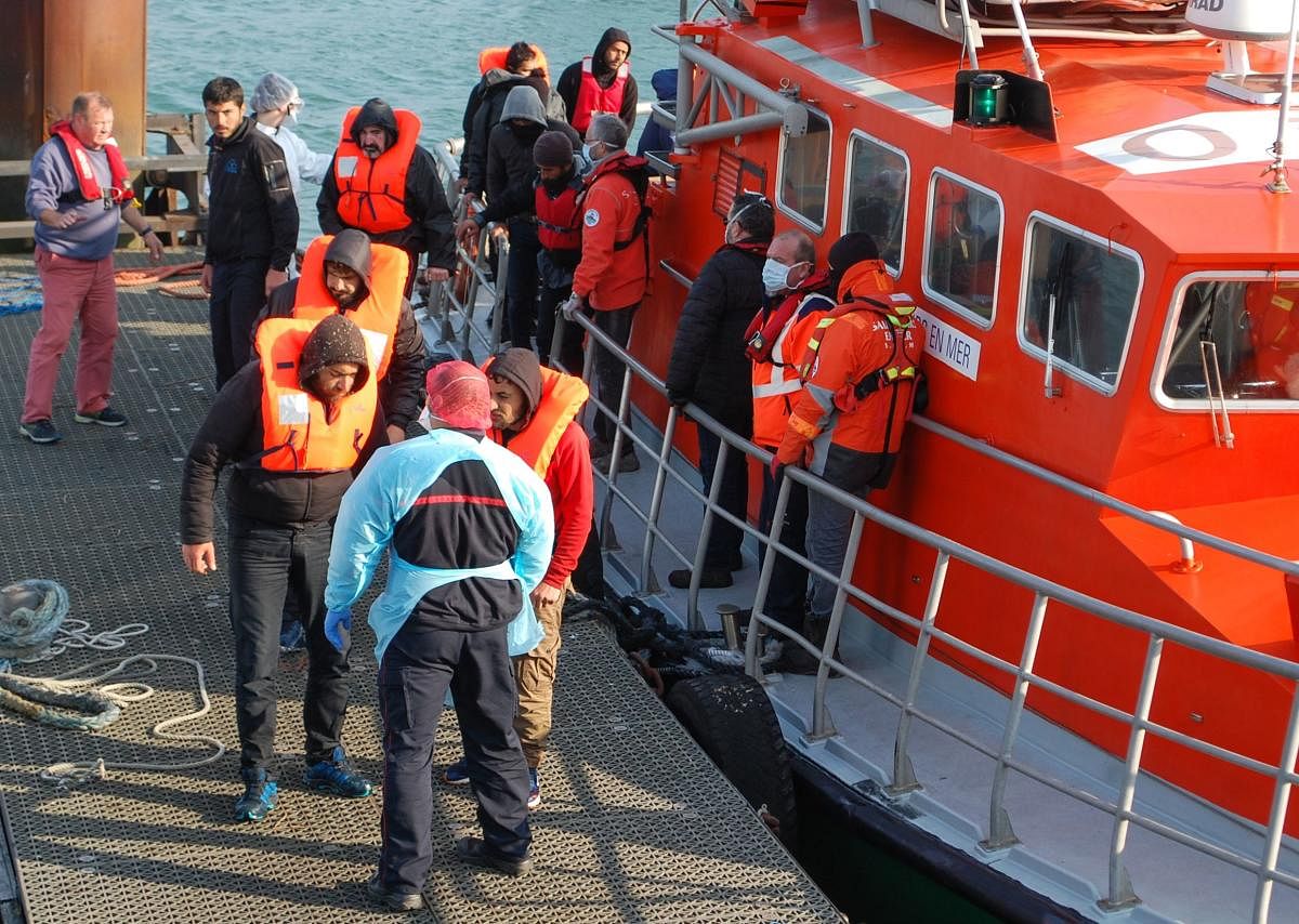 In this file photo taken on April 17, 2020 migrants disembark from the SNSM Calais life boat after being rescued off the coast of Calais trying to cross to Great Britain during the French nationwide lockdown aimed at curbing the spread of the COVID-19 disease, caused by the novel coronavirus. (AFP)