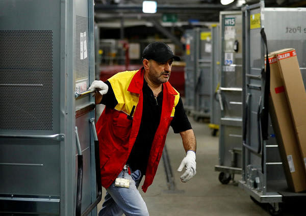 An employee works at a distribution centre of German postal and logistics group Deutsche Post DHL. Credit: Reuters