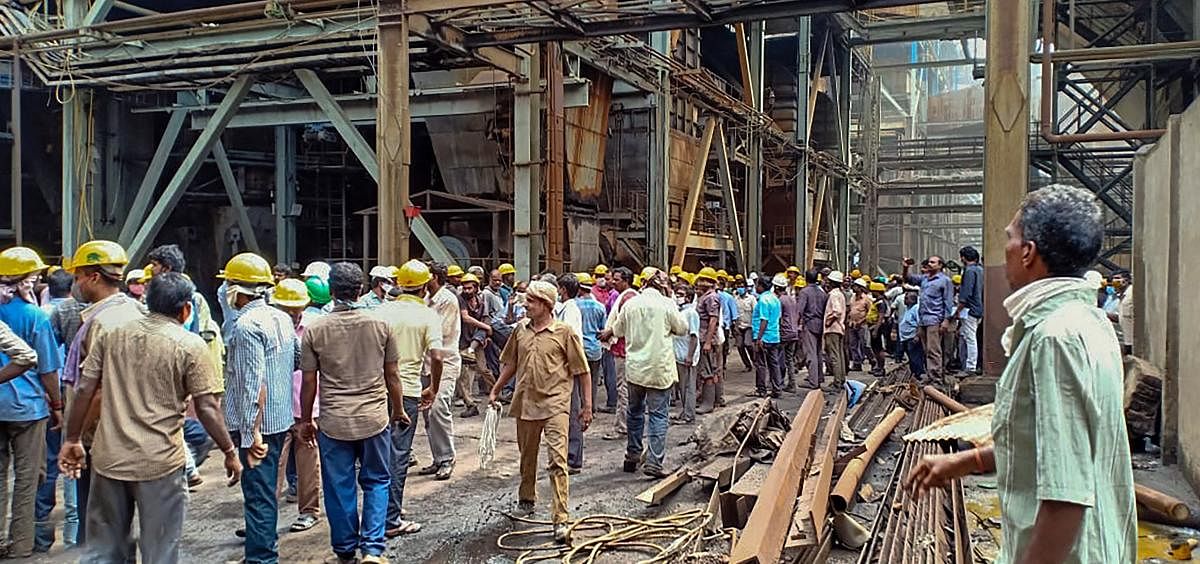 Workers stand outside Neyveli Lignite Corporation power plant following an explosion, in Cuddalore district. Credit: PTI