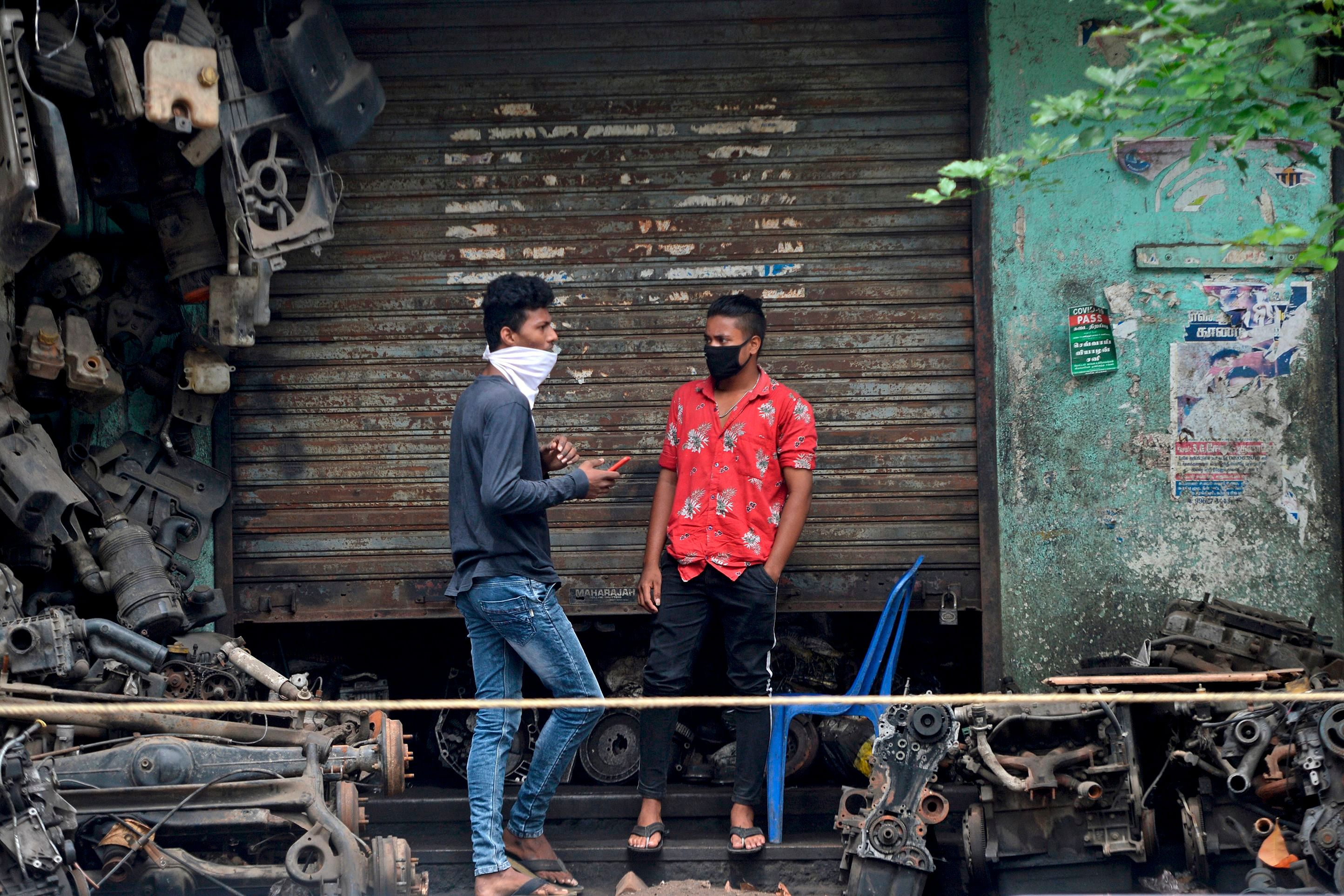 Shopkeepers wait for customers at a second hand automobile spare market in Chennai. Credit: AFP