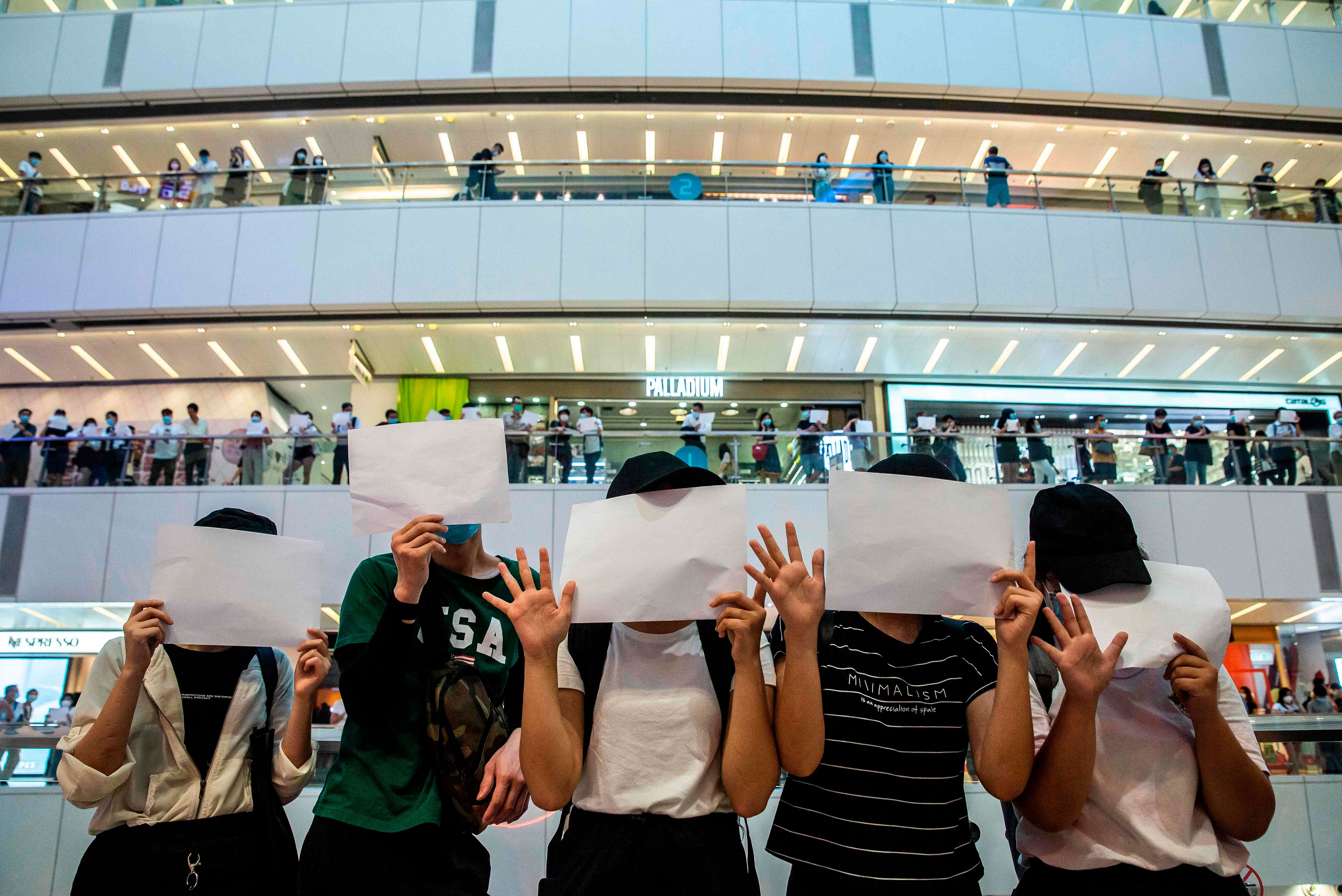 Protesters hold up blank papers during a demonstration in a mall in Hong Kong. Credits: AFP Photo