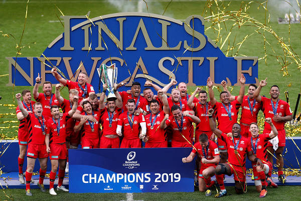 Saracens players celebrate winning the final with the European Champions Cup trophy at St James' Park, Newcastle, Britain on May 11, 2019. Credit: Reuters Photo