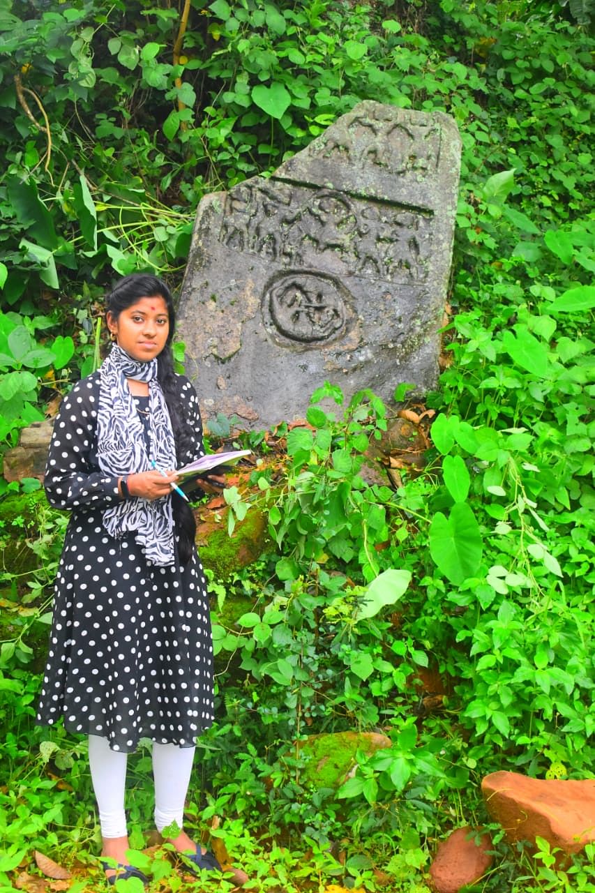 Supreetha KN, a researcher from Hampi Kannada University has discovered Karnataka's oldest hero stone on Malla Yuddha in Kalasa taluk of Chikkamagaluru district. Credit: DH Photo
