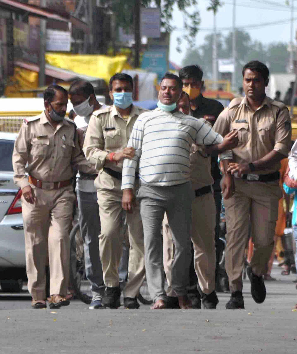 Notorious gangster Vikas Dubey, the main accused in killing of eight policemen in the Kanpur encounter recently, being apprehended by police personnel after a nearly week-long manhunt, in Ujjain, Thursday, July 9, 2020. (PTI Photo)
