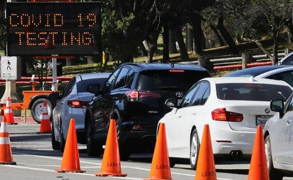 Motorists wait in line to enter the Covid-19 testing center at Dodger Stadium amid the coronavirus pandemic on July 08, 2020 in Los Angeles, California. Credit: AFP Photo