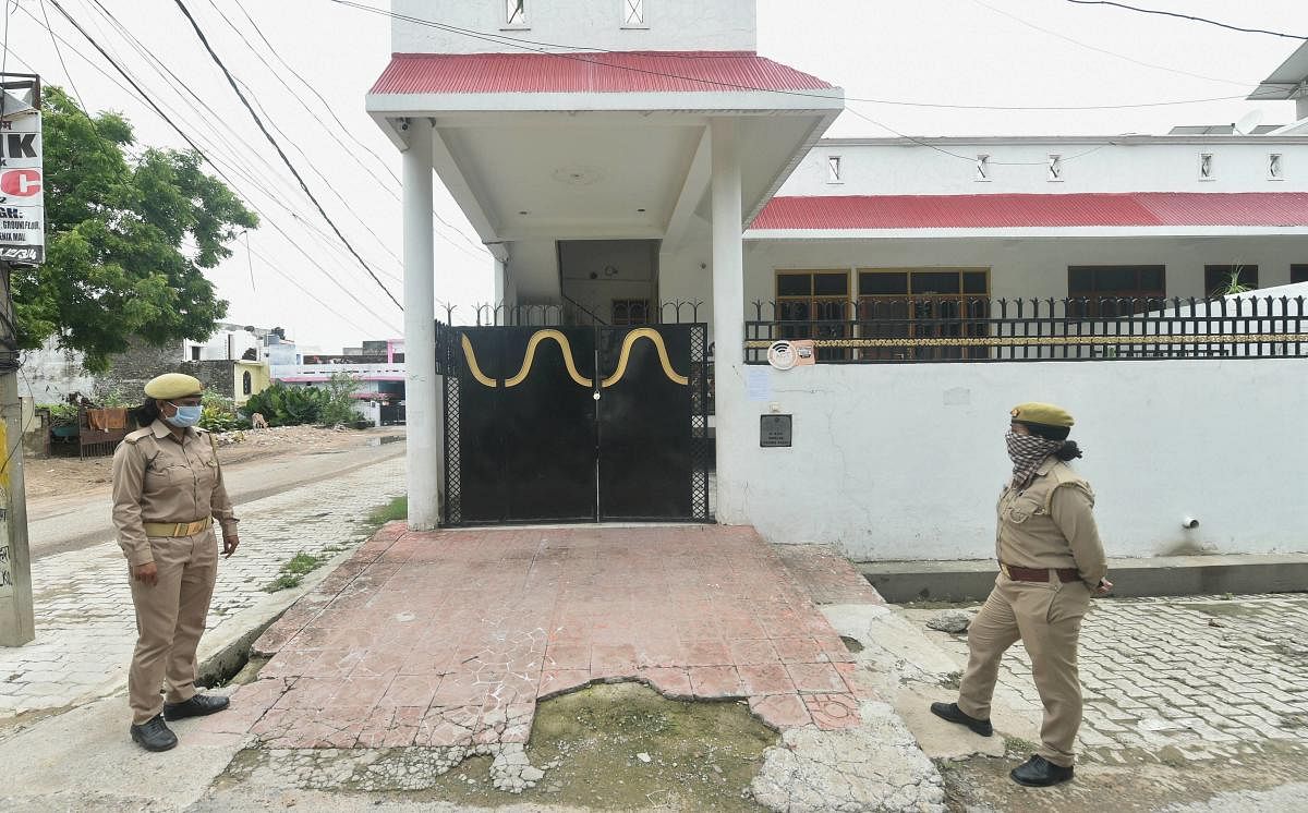 Police stand guard outside the residence of alleged gangster Vikas Dubey, in Lucknow. Credit: PTI Photo