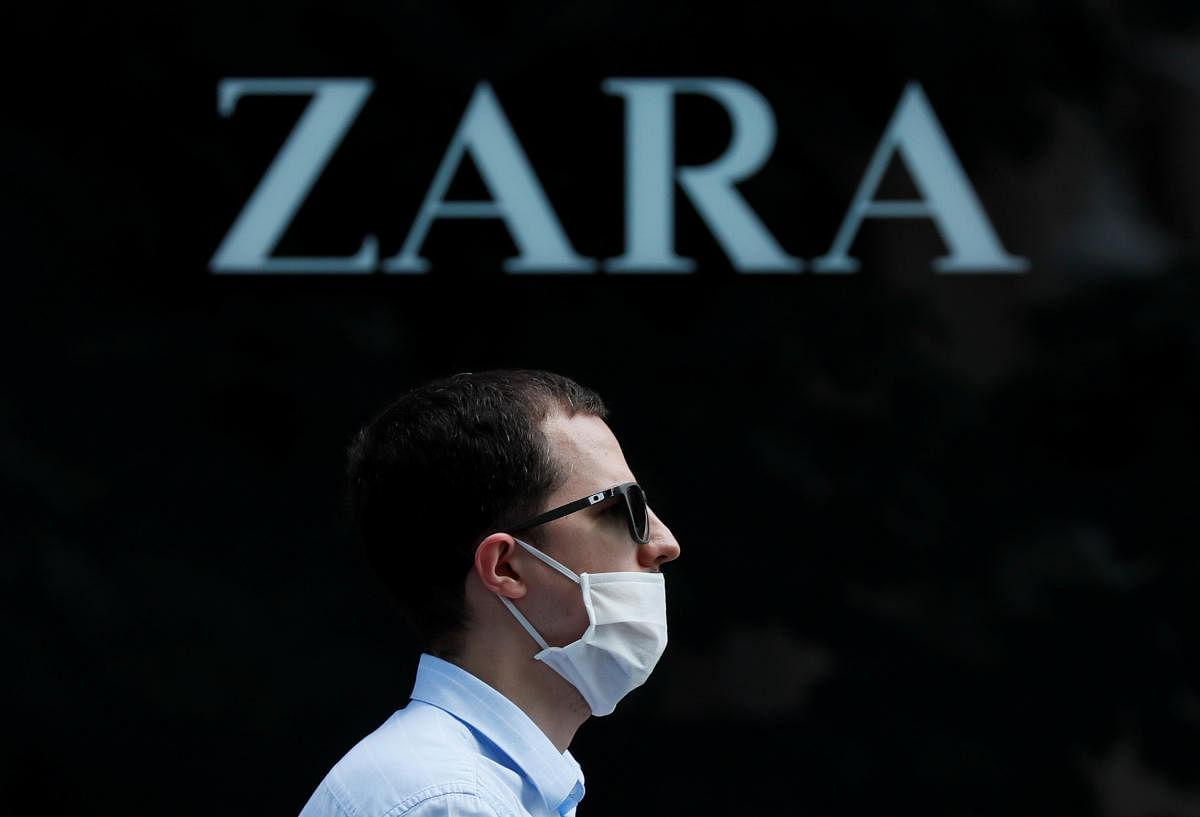 A man wearing a protective face mask walks past a Zara store (Reuters Photo)