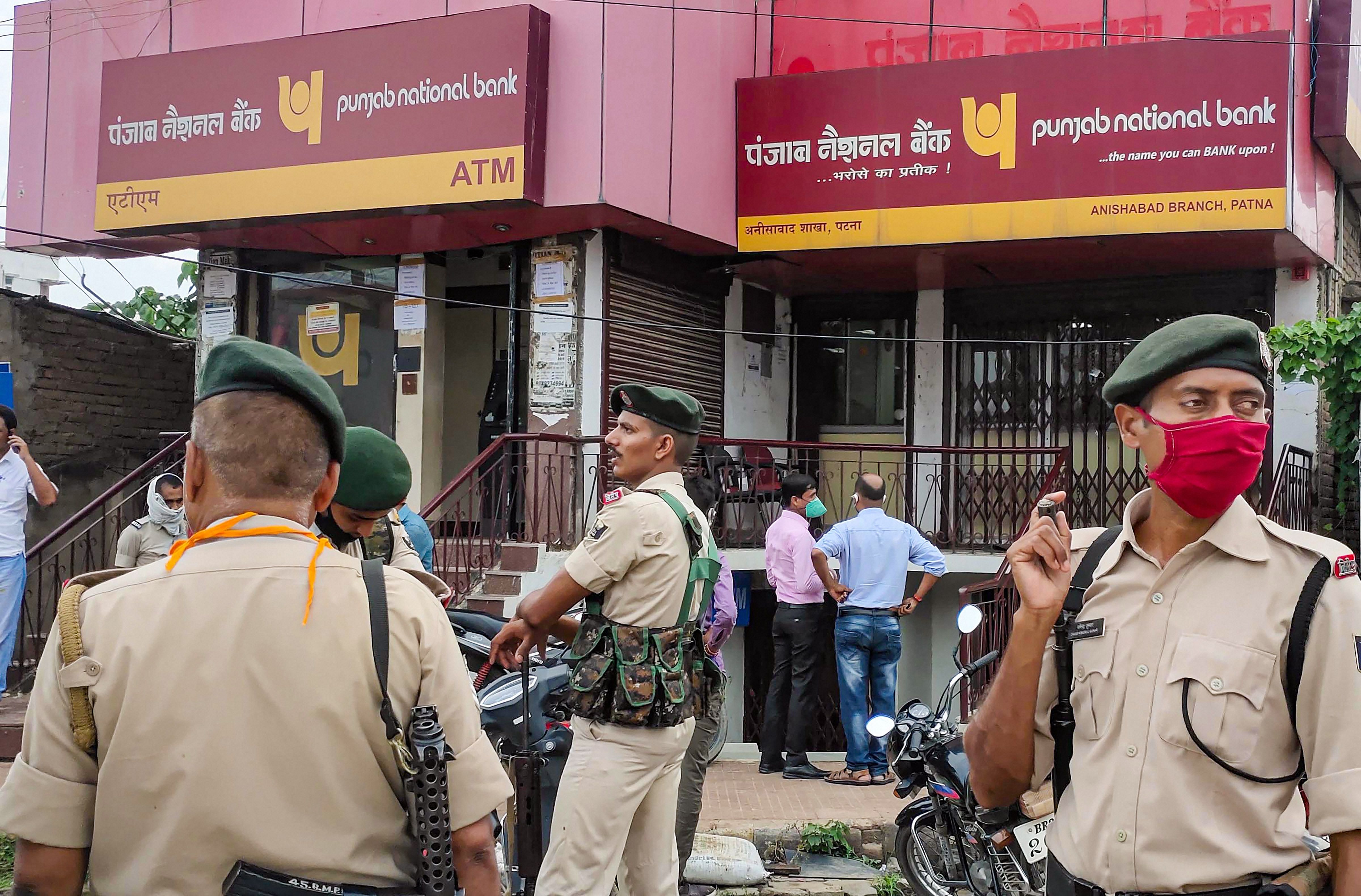 Police investigates the scene of crime after two armed men carried out daylight robbery at Punjab National Bank (PNB), in Patna. Credits: PTI Photo