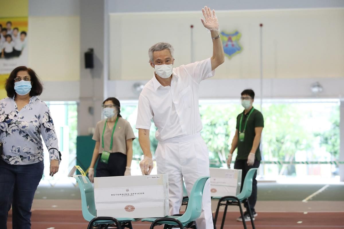 Prime Minister Lee Hsien Loong (C) waving as he cast his vote at Alexandra Primary School during the general election in Singapore. Credit: AFP Photo