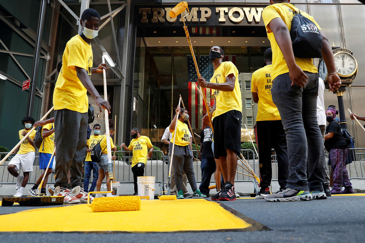 People paint a "Black Lives Matter" along 5th avenue outside Trump Tower in the Manhattan borough of New York City, New York, U.S. Credit: Reuters