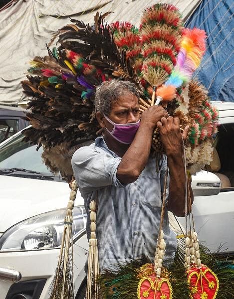  A hawker sells car-dusters during Unlock 2.0, in Kolkata. Credit: PTI Photo