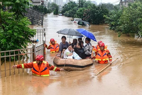 Rescuers evacuate flood-affected residents following heavy rain in Jiujiang in China's central Jiangxi province. Credit: AFP Photo