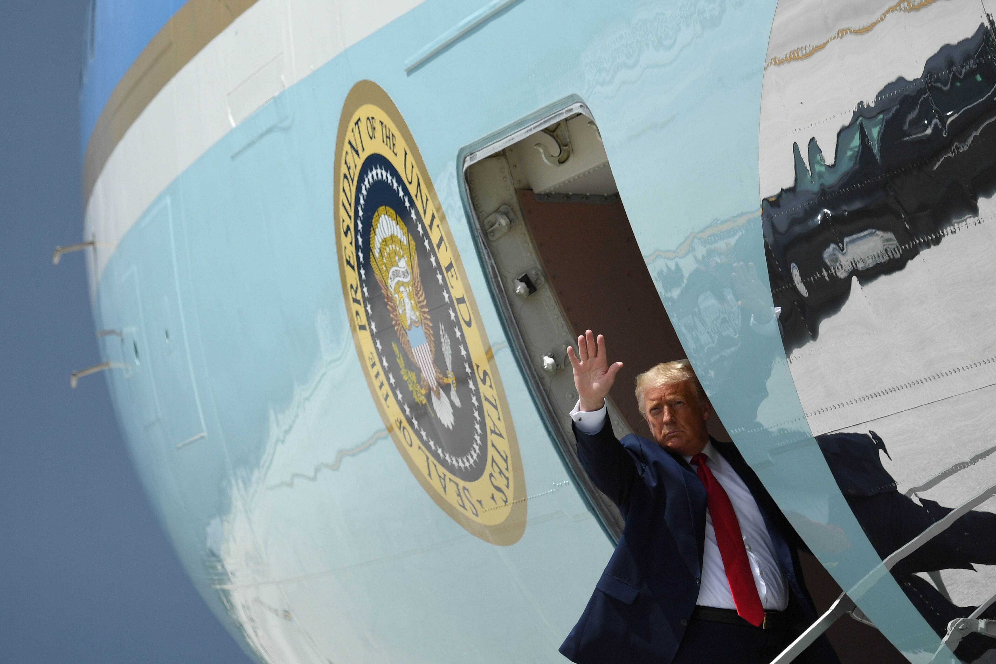 US President Donald Trump waves as he boards Air Force One prior to departure from Miami International Airport in Miami. Credits: AFP Photo