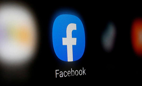 A Facebook logo is displayed on a smartphone. Credit: Reuters