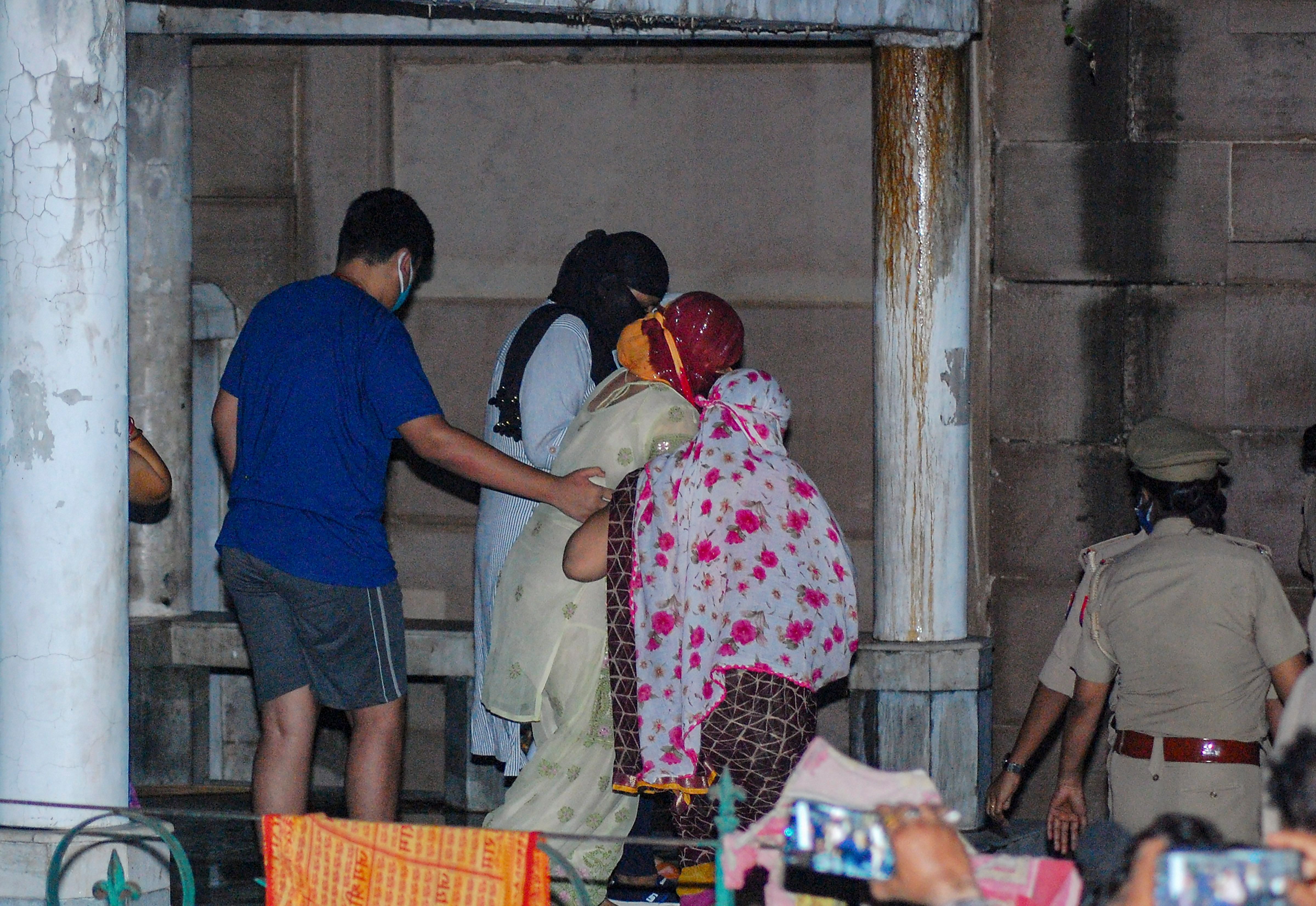 Notorious gangster Vikas Dubey's wife and son leave after his cremation at Bhairav Ghat Hindu Crematory. Credits: PTI Photo