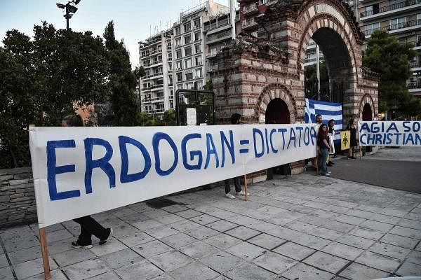People demonstrate with banners and Greek national flags outside the Agia Sofia church of Thessaloniki, to protest after top Turkish court revoked Istanbul's Hagia Sophia monument's 1934 status as a museum. Credit: AFP