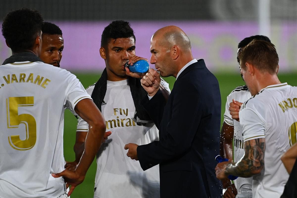 Real Madrid's French coach Zinedine Zidane (C) speaks to players during the Spanish League football match between Real Madrid and Alaves at the Alfredo Di Stefano stadium in Valdebebas near Madrid on July 10, 2020. Credit: AFP