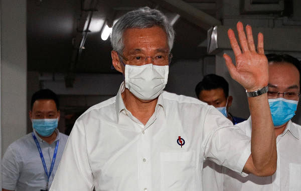 Singapore's Prime Minister Lee Hsien Loong waves as he arrives at a People's Action Party branch office. Credit: Reuters
