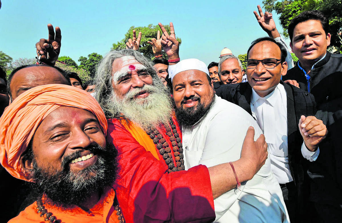 New Delhi: People belonging to Hindu and Muslim faiths celebrate the Ayodhya case, outside the Supreme Court in New Delhi, Saturday, Nov. 9, 2019. (PTI Photo/Manvender Vashist) (PTI11_9_2019_000082B)