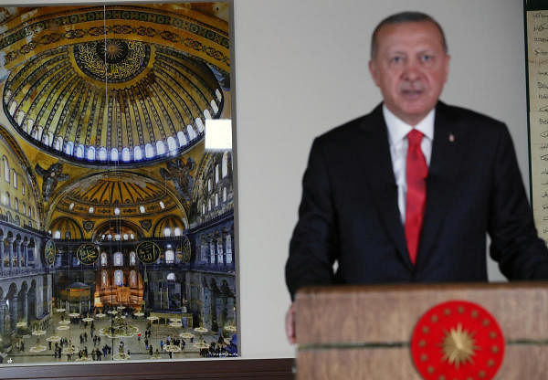 Turkish President Tayyip Erdogan, with a picture of Hagia Sophia or Ayasofya in the background, delivers a televised address to Turkey. Credit: Reuters Photo