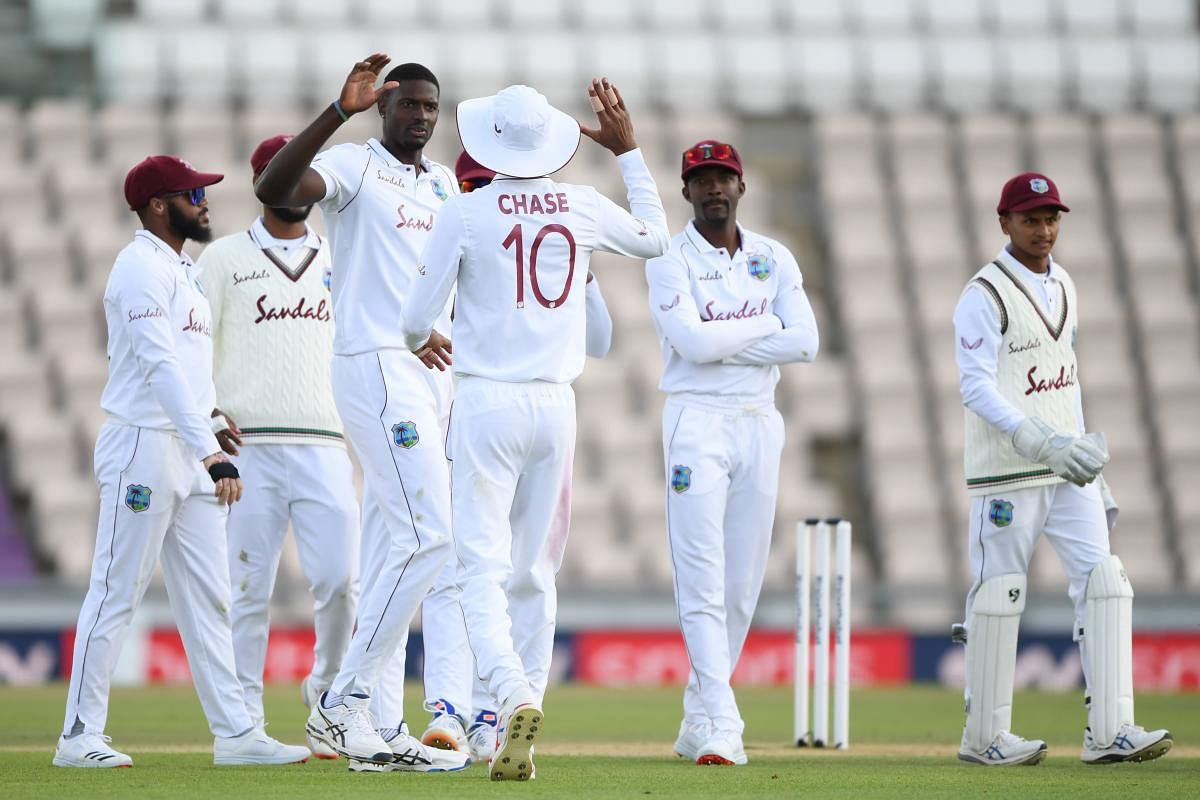 West Indies' Jason Holder (C) celebrates with teammates after dismissing England's Ben Stokes on the fourth day of the first Test cricket match between England and the West Indies at the Ageas Bowl in Southampton. Credit: AFP