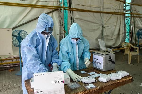 Medical staff arrange material for rapid antigen tests for Covid-19. Credit: AFP