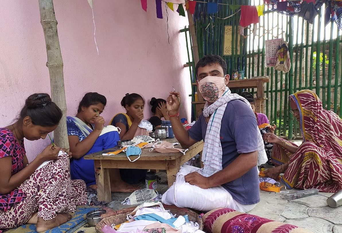 Madhubani artist Remant Kumar Mishra’s hand-painted masks went viral on social media. Credit: Twitter/ @remantkumarmish