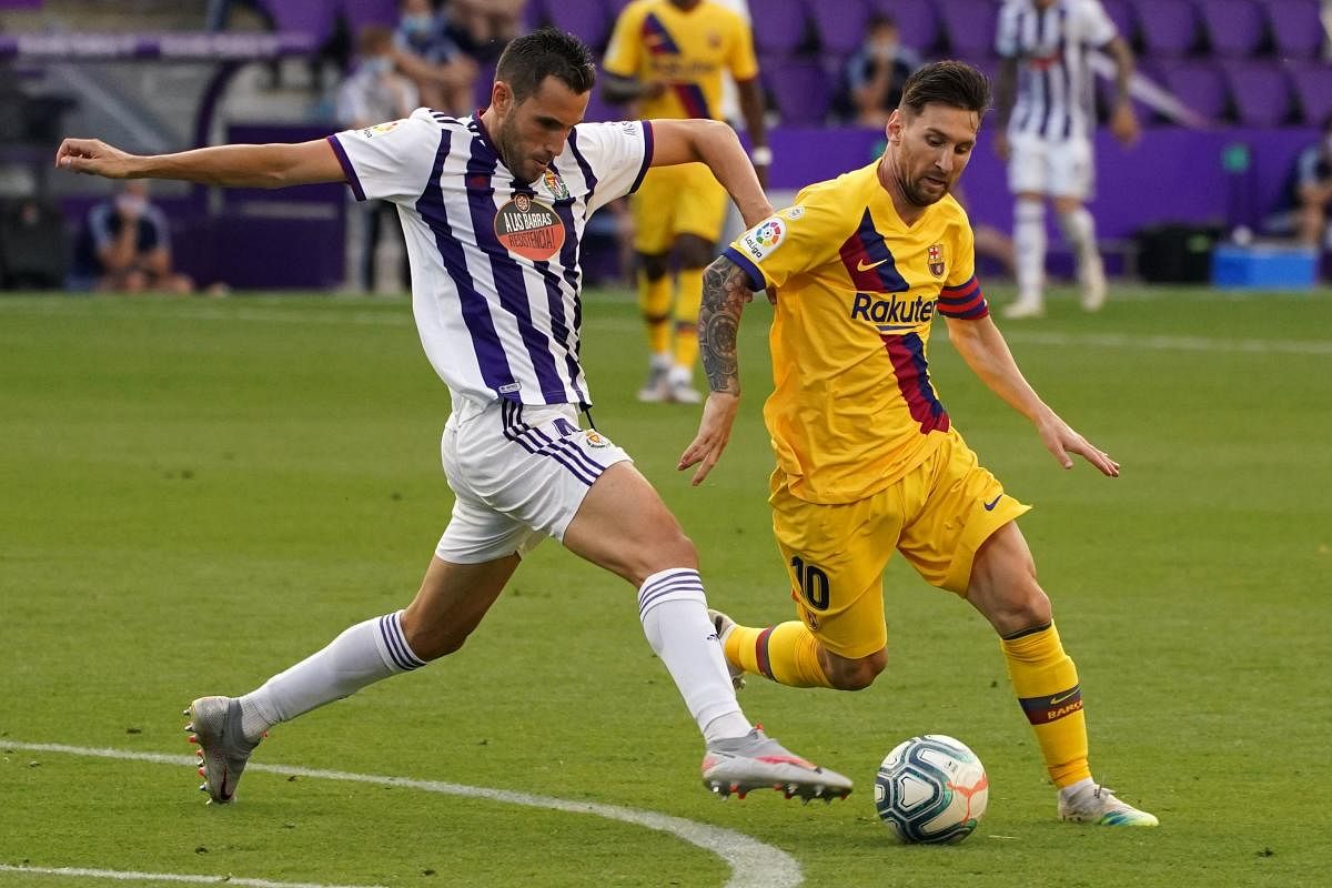 Real Valladolid's Spanish defender Kiko Olivas (L) vies with Barcelona's Argentinian forward Lionel Messi during the Spanish league football match between Real Valladolid FC and FC Barcelona at the Jose Zorrilla stadium in Valladolid on July 11, 2020. Credit: AFP
