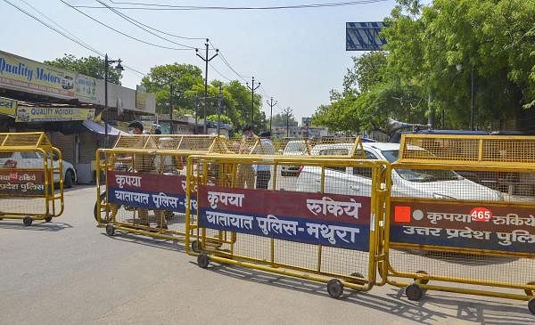Police barricades put on a road to block the movement of people towards Hathras and Aligarh districts, during a lockdown in Mathura, Sunday, July 12, 2020. Credit: PTI