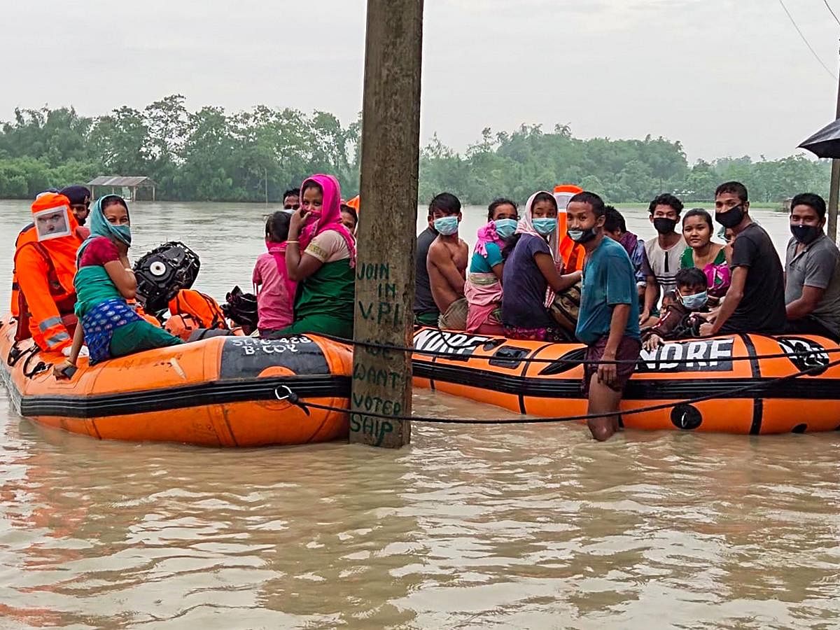 NDRF personnel rescue villagers from a flood affected area, in Barpeta district, Saturday, July 11, 2020. Credit: PTI Photo
