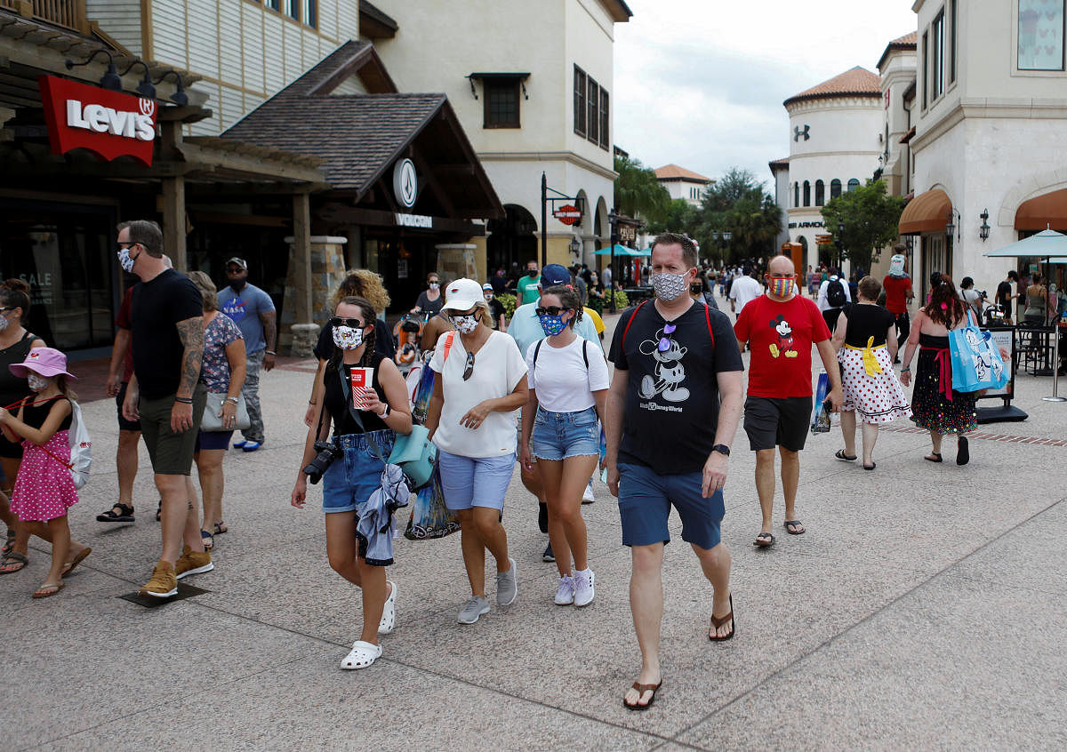 Disney Springs shoppers wear face masks and Disney-themed clothing while Walt Disney World conducts a phased reopening from coronavirus disease (COVID-19) restrictions in Lake Buena Vista, Florida, U.S. July 11, 2020. Credit: Reuters Photo