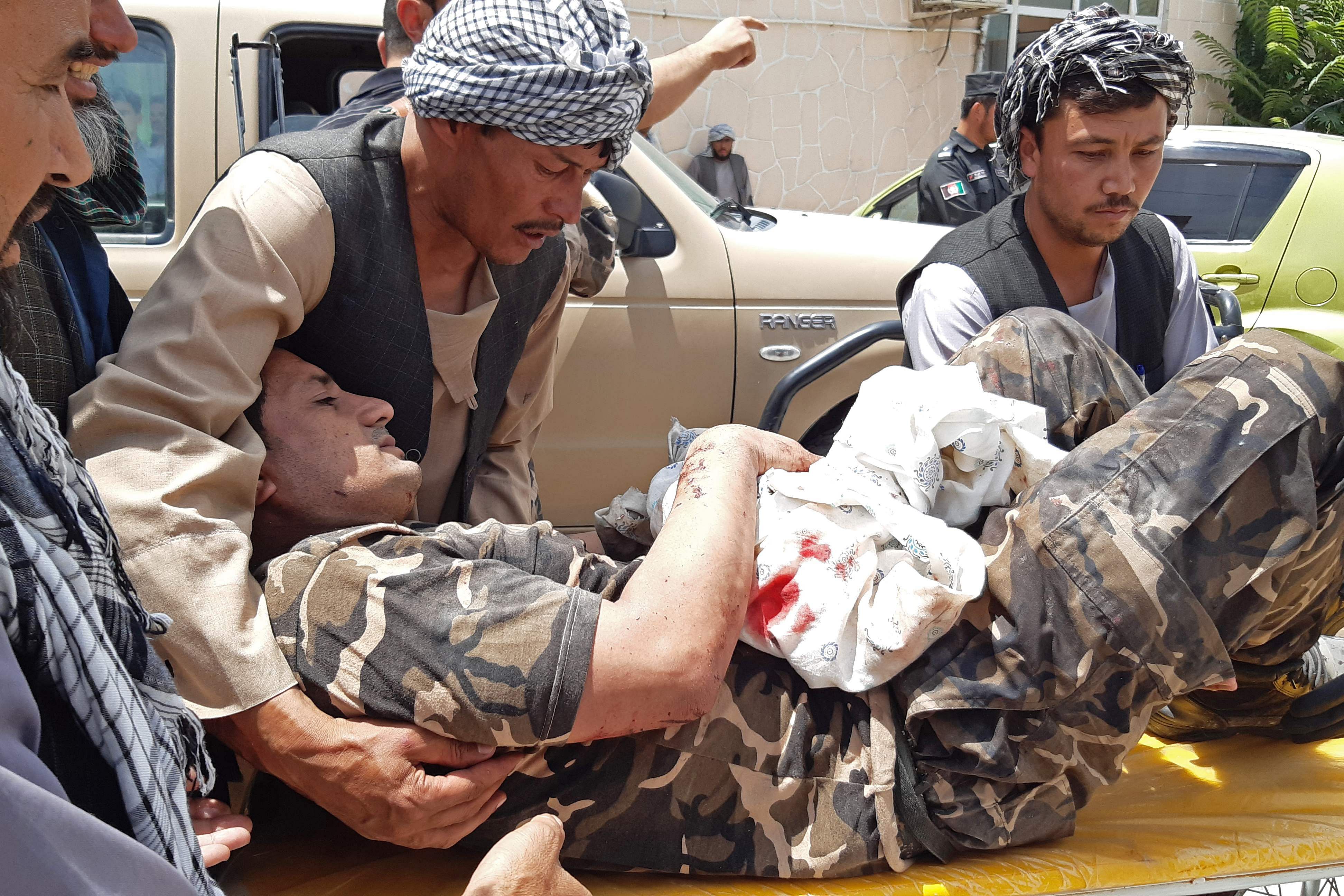 A wounded personnel of National Directorate of Security (NDS) is brought on a stretcher to a hospital after a car bomb exploded in the city of Aybak, in Samangan province. Credits: AFP Photo