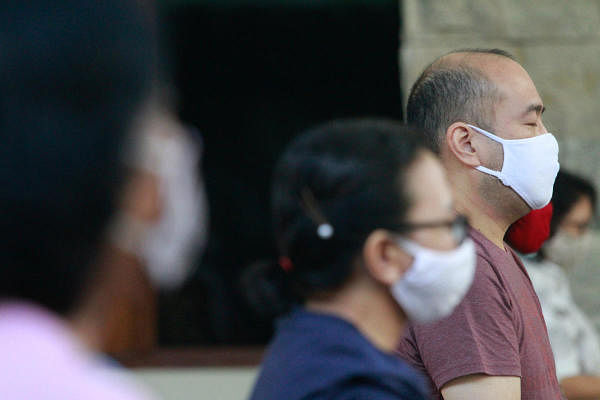 People wearing protective face masks amid the coronavirus outbreak, in Jakarta. Credit: Reuters