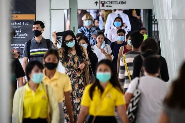 People wearing face masks as a measure to prevent the spread of the Covid-19 in Bangkok. Credit: AFP