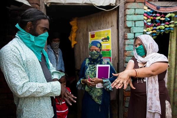 A health activist raises awareness of the novel coronavirus, in Uttar Pradesh. Credit: AFP