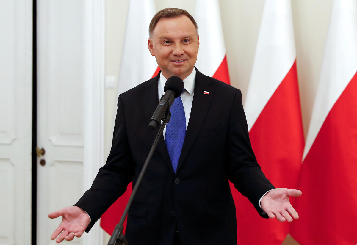 Polish President and presidential candidate of the Law and Justice (PiS) party Andrzej Duda talks to the media after the announcement of the first exit poll results on the second round of the presidential election. Credit: Reuters Photo