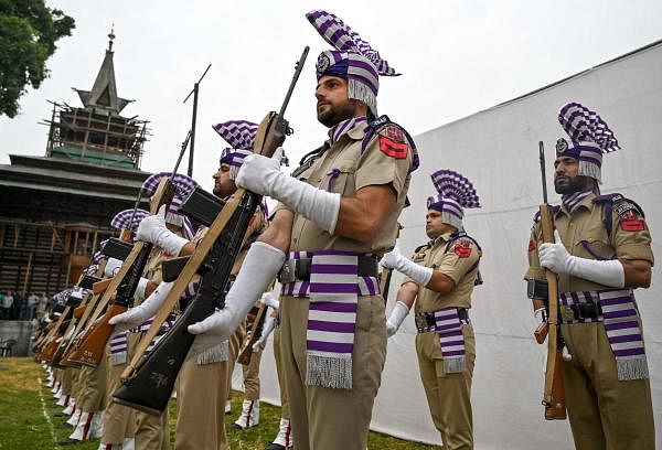 Indian police guard of honour personnel attend a ceremony to mark the 87th anniversary of Kashmiris slain by the army of a Hindu king, at the Mazar-e-Shohda (Martyr's graveyard) in Srinagar on July 13, 2019. Credit: AFP Photo