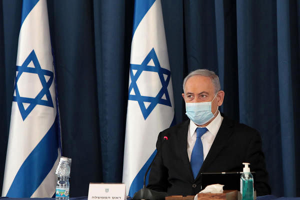 Israeli Prime Minister Benjamin Netanyahu wears a protective mask as he opens the weekly cabinet meeting. Credit: AFP Photo