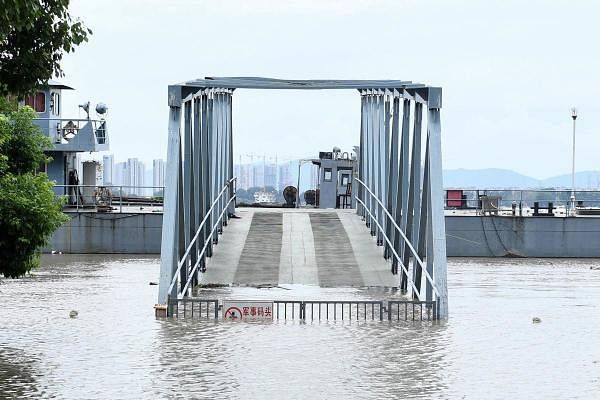 A ramp to a docking area is seen partially submerged in floodwaters on the bank of the Yangtze River in Nanjing in China's eastern Jiangsu province. Credit: AFP Photo
