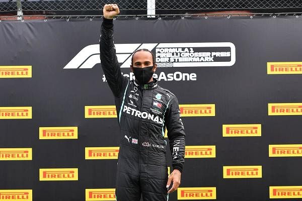 Winner Mercedes' British driver Lewis Hamilton celebrates on the podium after the Formula One Styrian Grand Prix race on July 12, 2020 in Spielberg, Austria. Credit: AFP Photo