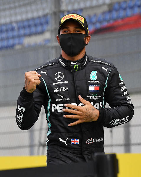 Mercedes' British driver Lewis Hamilton celebrates after the Formula One Styrian Grand Prix race on July 12, 2020 in Spielberg, Austria. Credit: AFP Photo