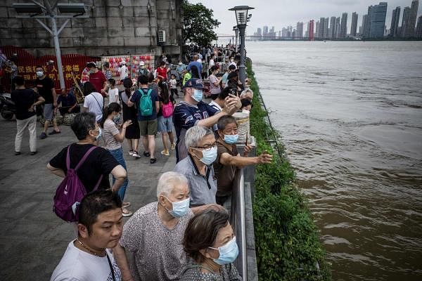 Residents looking at the swollen Yangtze River in Wuhan in China's central Hubei province. Credit: AFP Photo