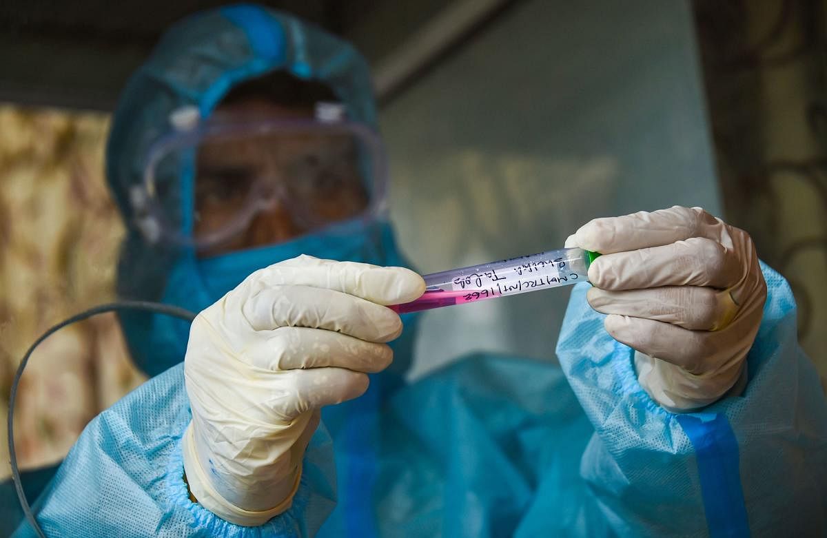 A health official takes samples for Covid-19 testing, during Unlock 2.0, in Srinagar. Credit: PTI Photo