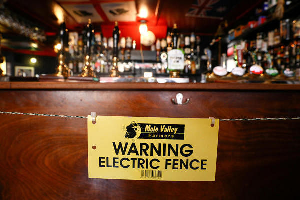 An electric fence installed at the bar area of The Star Inn, to ensure customers are socially distanced from staff while ordering drinks, following the outbreak of the coronavirus disease, in Cornwall, Britain, on July 14, 2020. Credit: Reuters Photo